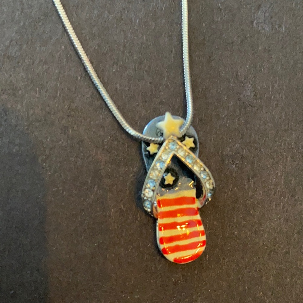Silver tone 17” necklace with four sandal charms.